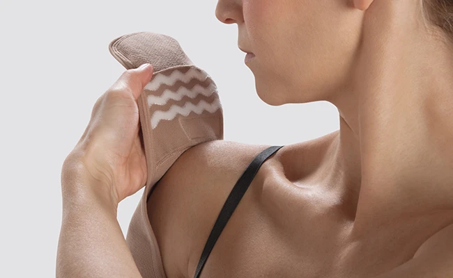 female model showing silicone stopper options of a compression sleeve at her shoulder.